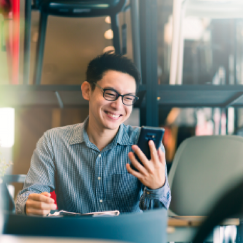 Smiling man with phone in his hand